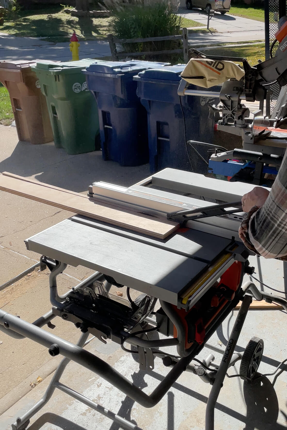 Using a table saw to cut down cleats for a DIY floating bathroom shelf.